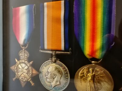 Three Great War campaign medals in a glass display case at Soldiers of Oxfordshire Museum.